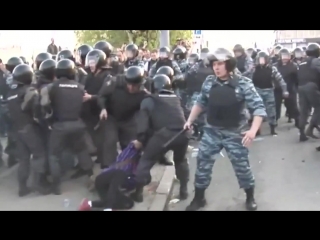 the policeman kicks the detained girl in the groin area